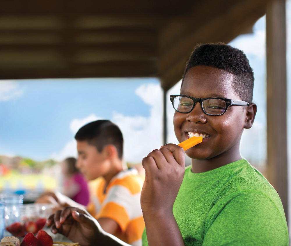 Young Man eating Nutritious Food with the YMCA program
