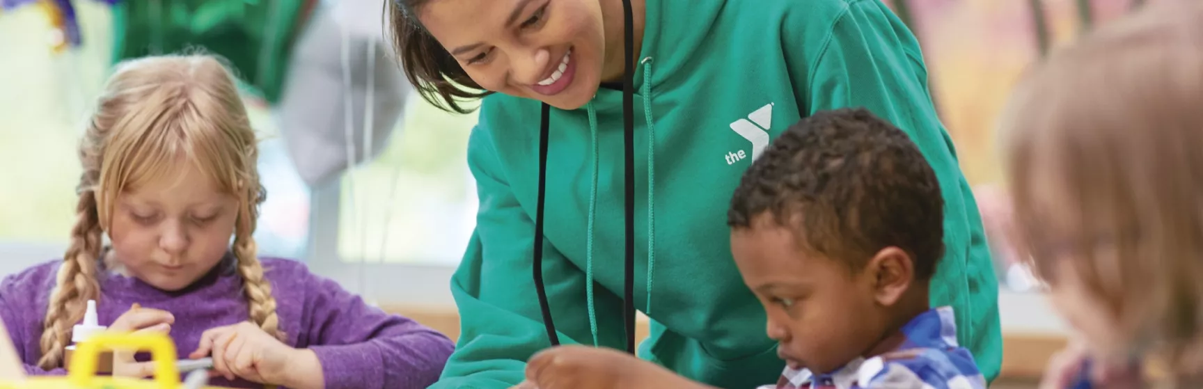 Teacher helping in preschool